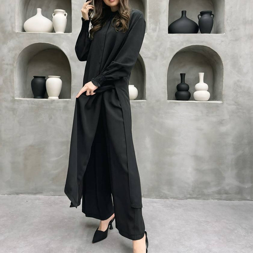 Side view showing high slit hem and wide leg pants coordination