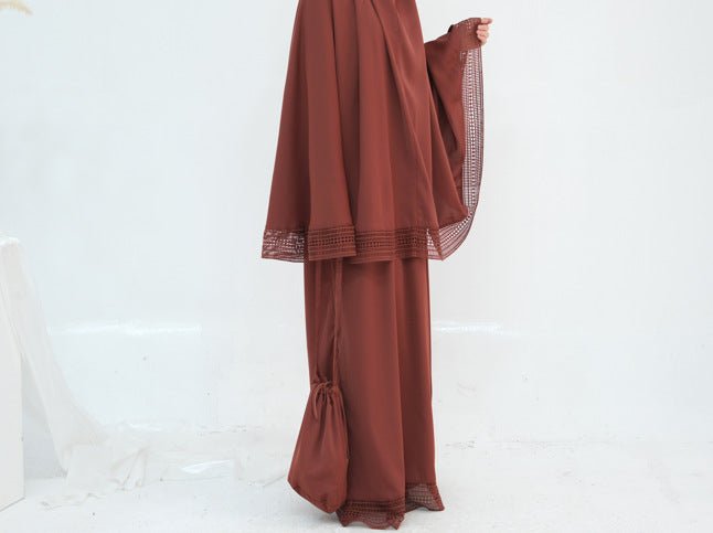 Front view of prayer dress showing attached hood and lace sleeve trim
