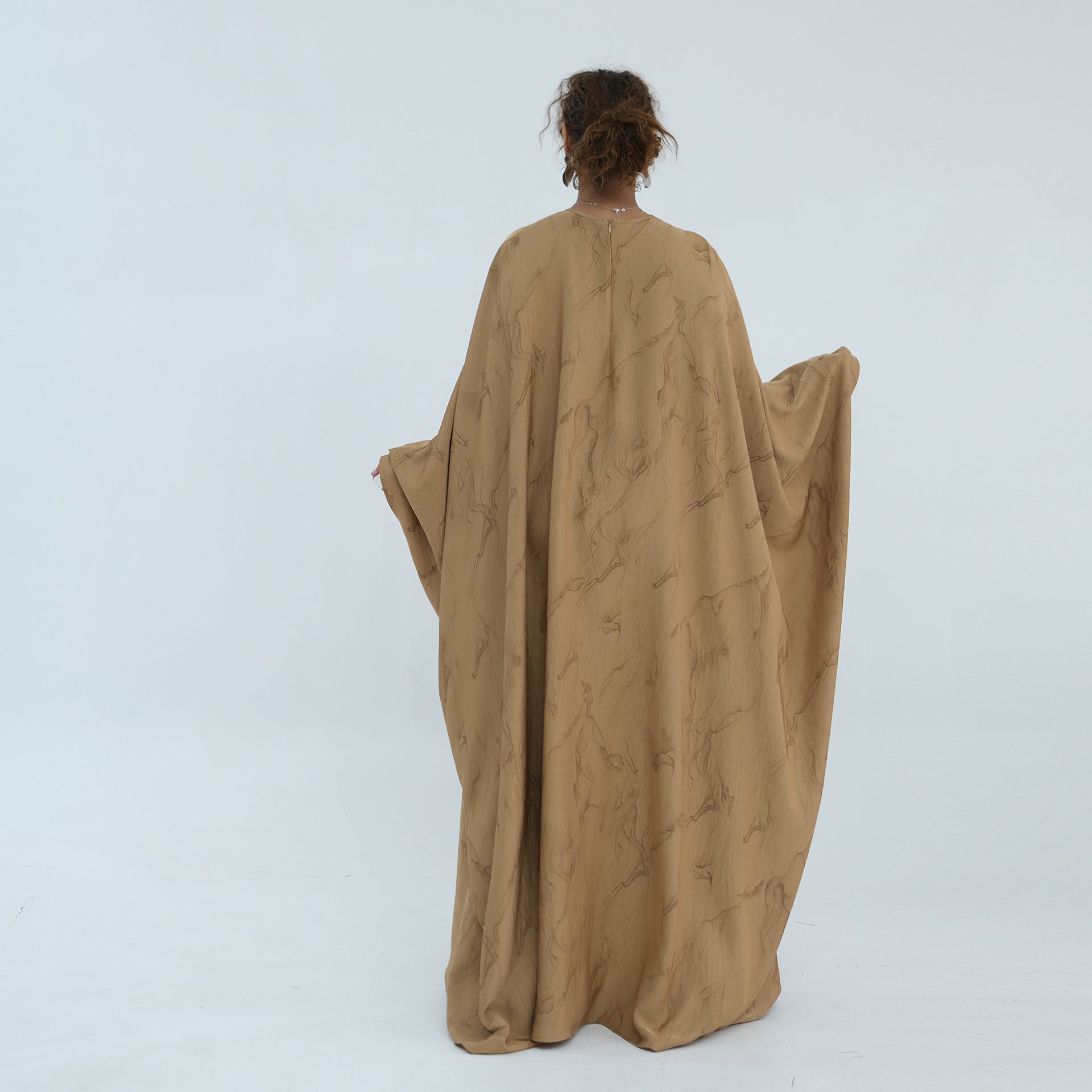 Unbelted flowing silhouette of the gold print batwing sleeve maxi dress
