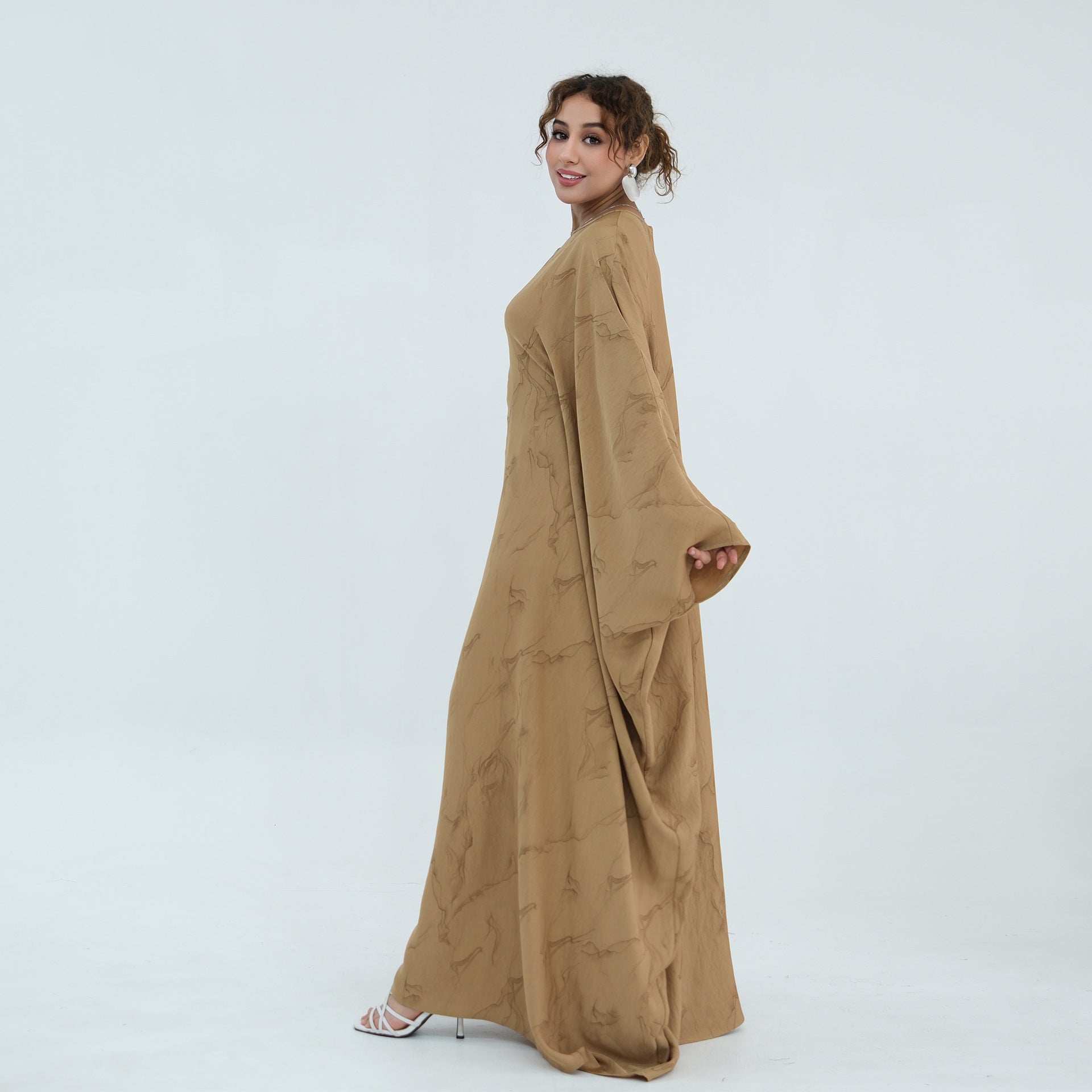 Full-length front view of belted gold print batwing maxi dress