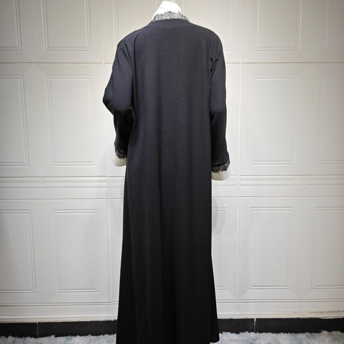 Styled look wearing lace panel open abaya as a layering piece