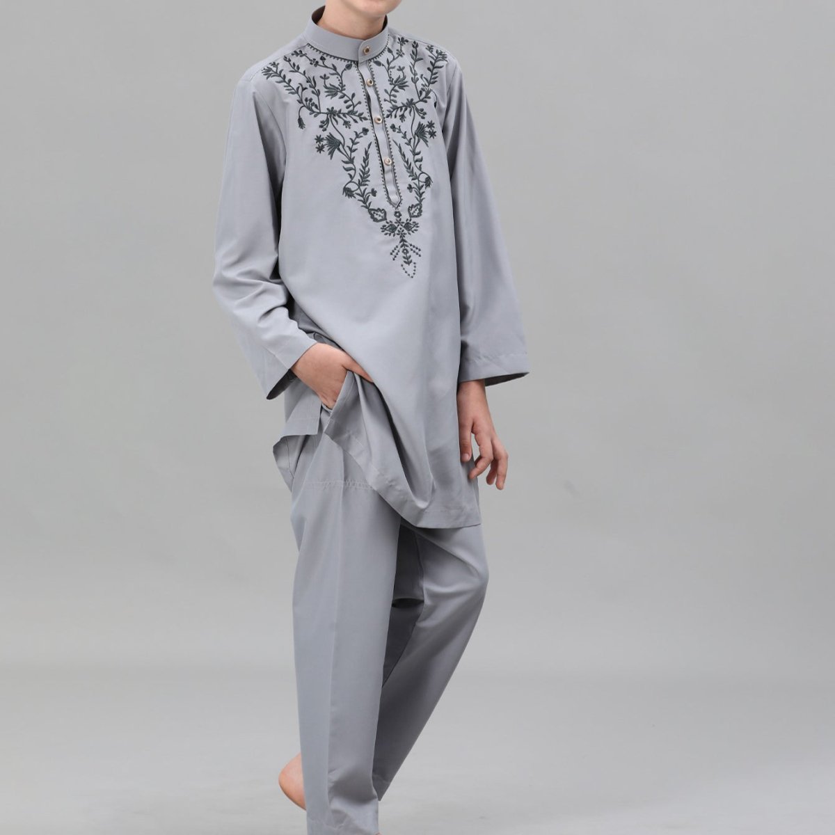 Close-up of black vine and floral embroidery on boys' thobe chest panel