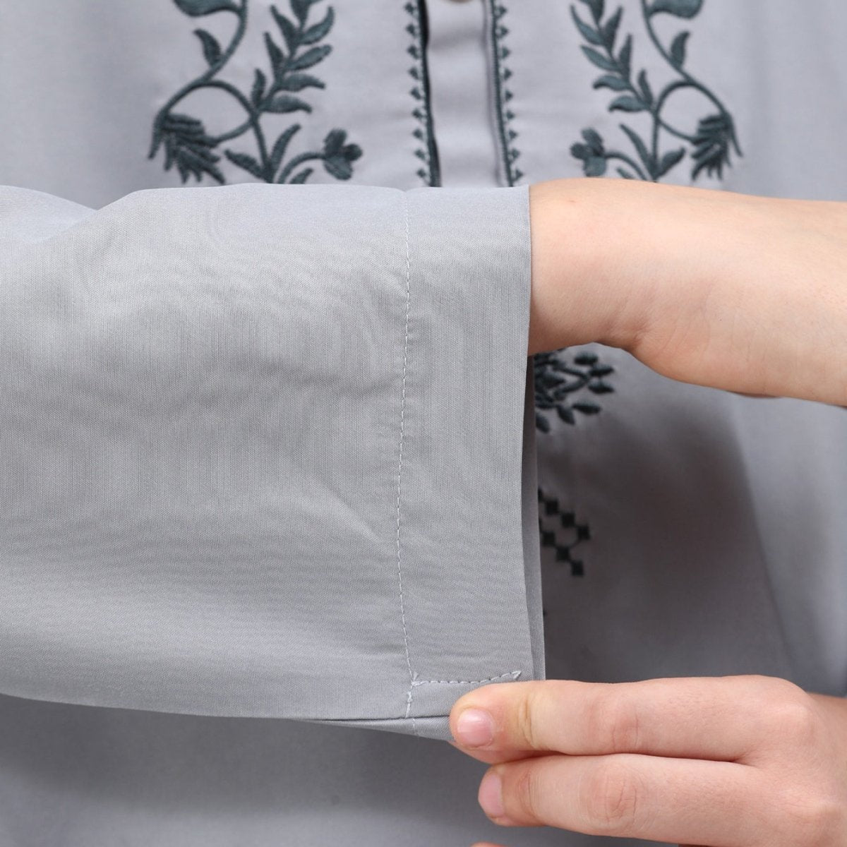 Full-length side view of boys' embroidered thobe set with side slit detail