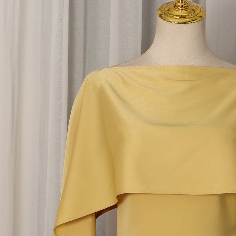 Side profile of fitted golden party abaya showing cape silhouette