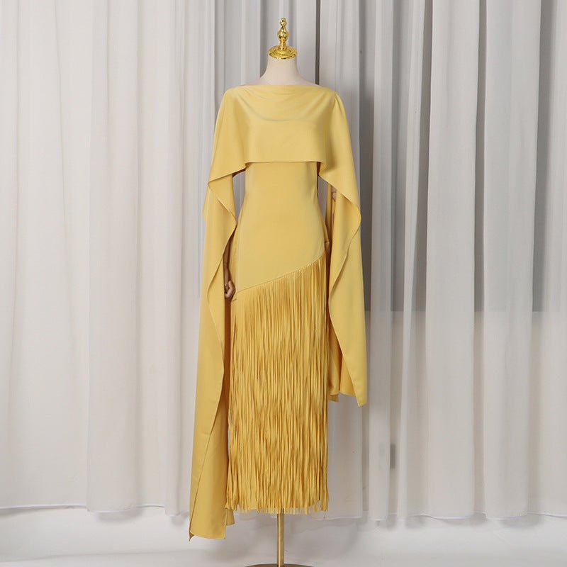 Front view of golden yellow crepe cape overlay dress with fringe panel