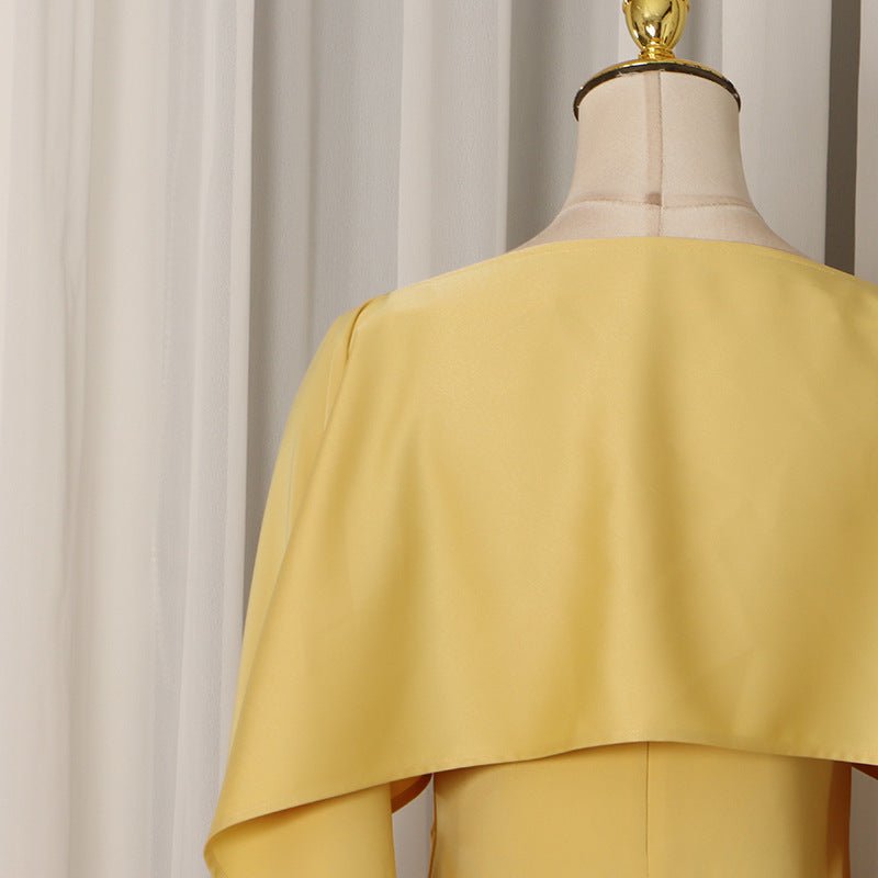 Back view of cape overlay fringe hem dress in premium crepe fabric