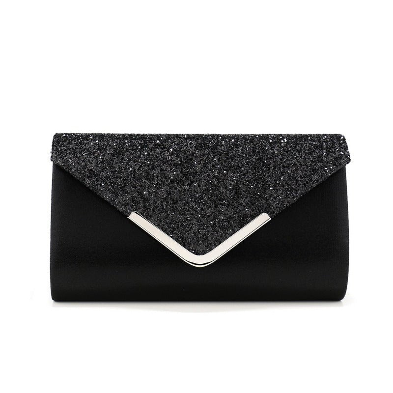 Magnetic snap closure detail on glitter envelope clutch