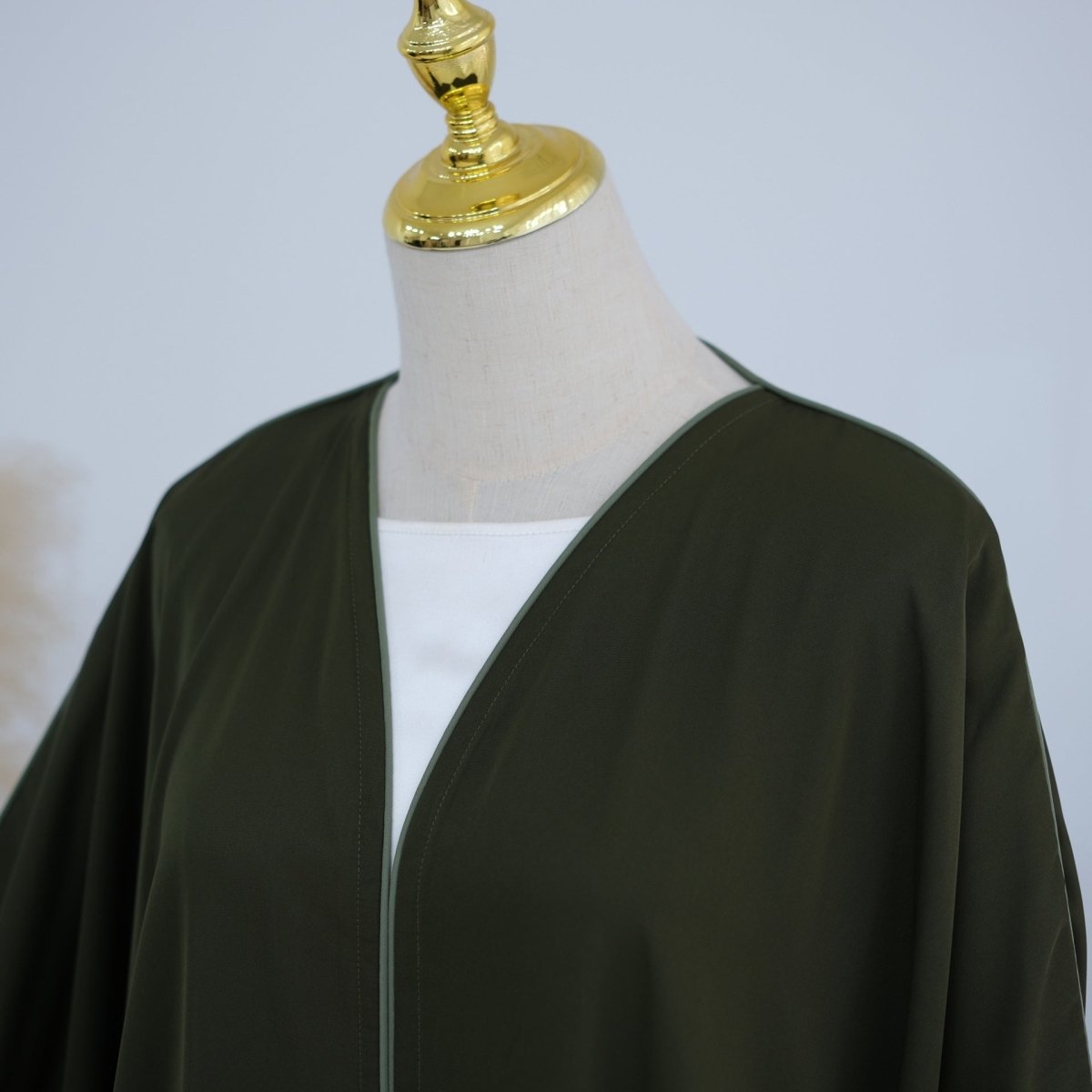 Floor-length hem of batwing open abaya showing smooth fabric drape