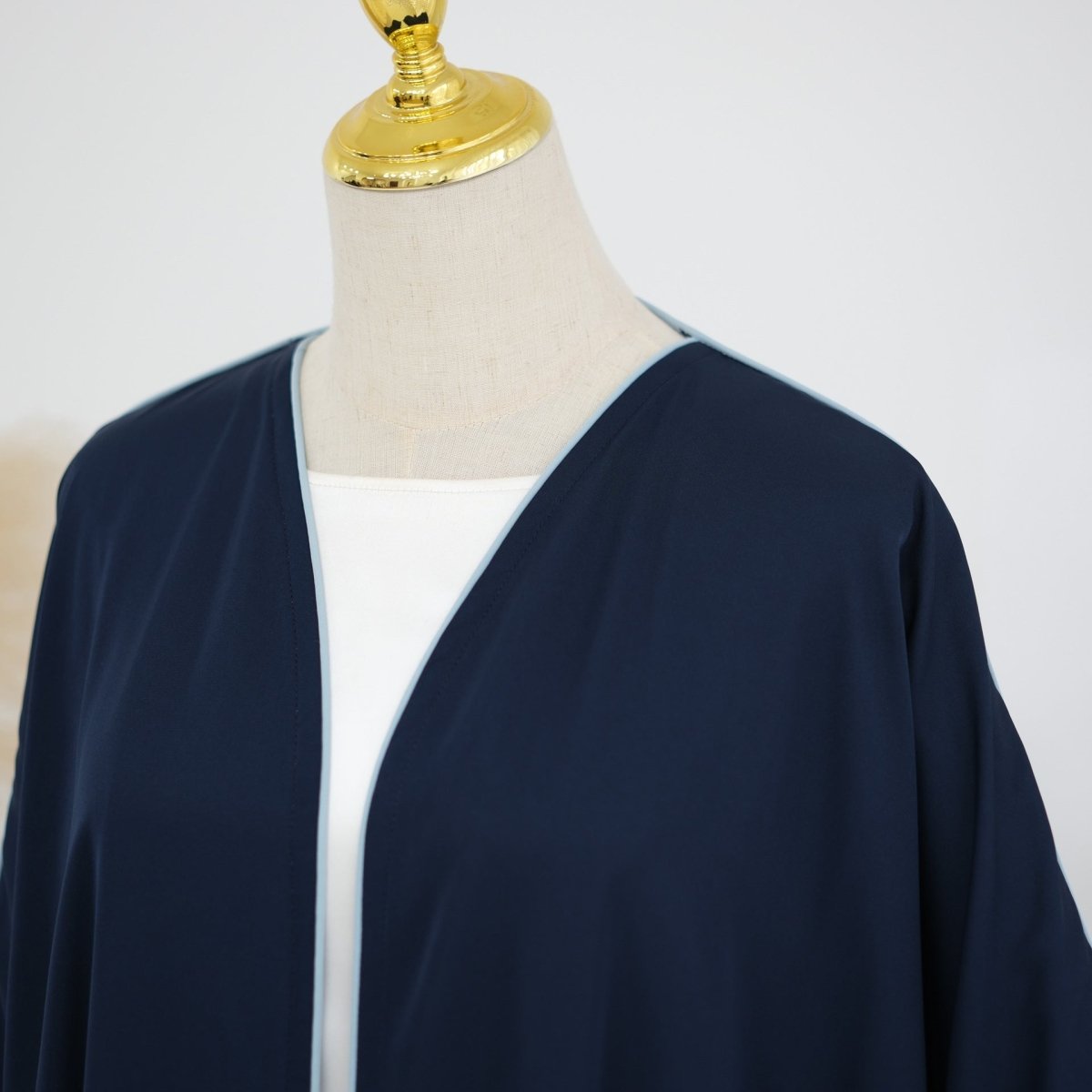 Oversized batwing sleeve detail sweeping from shoulder to wrist