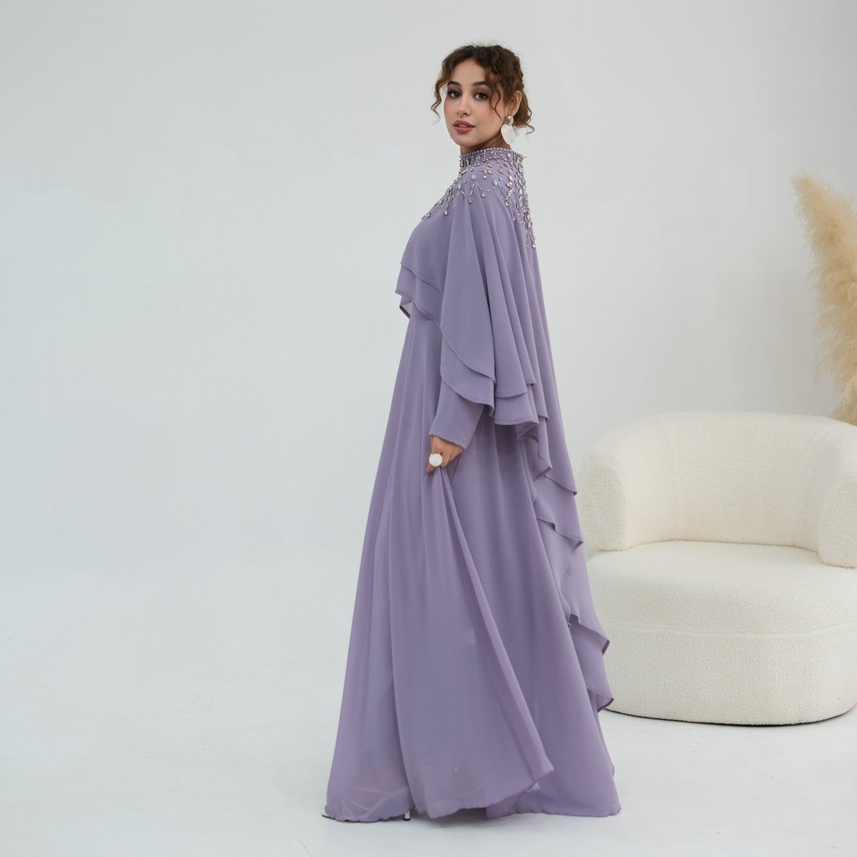 Flared cuff detail with single gold button closure on long inner sleeve