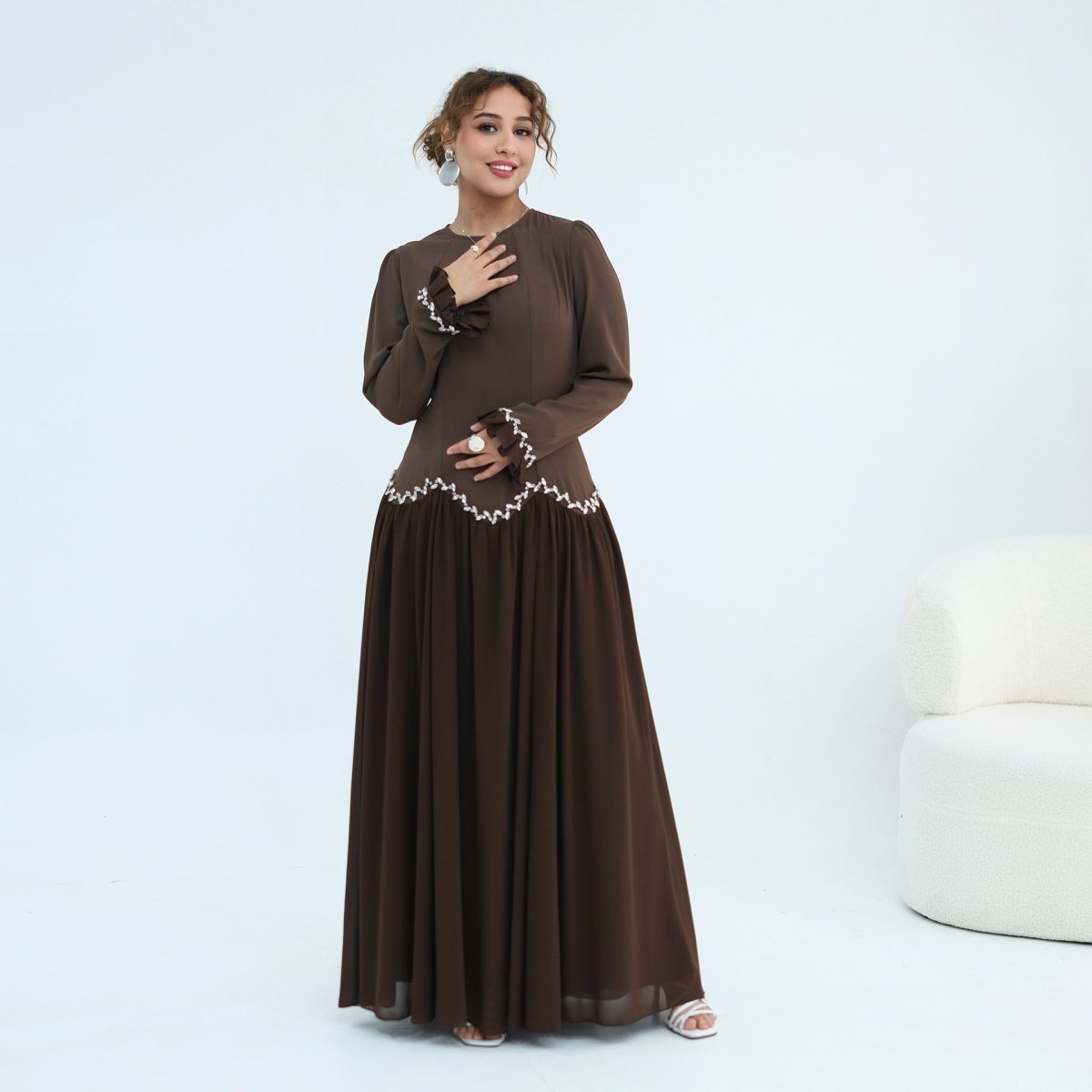 Slender self-tie belt cinching the waist seam