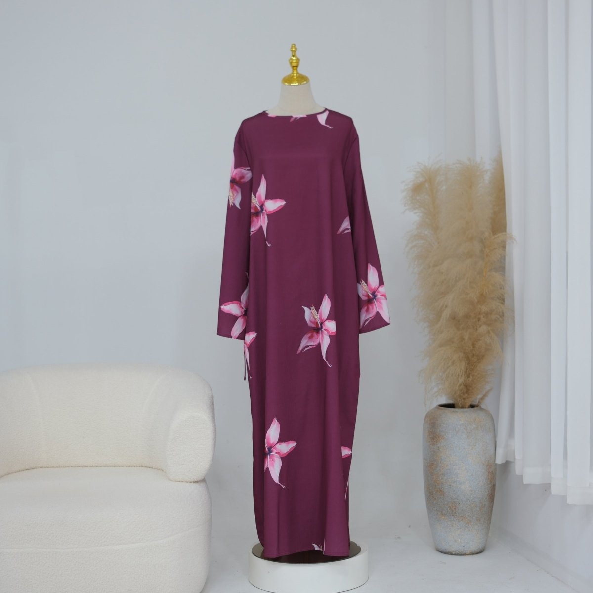 Full-body standing shot of modest floral print maxi dress with cape sleeves