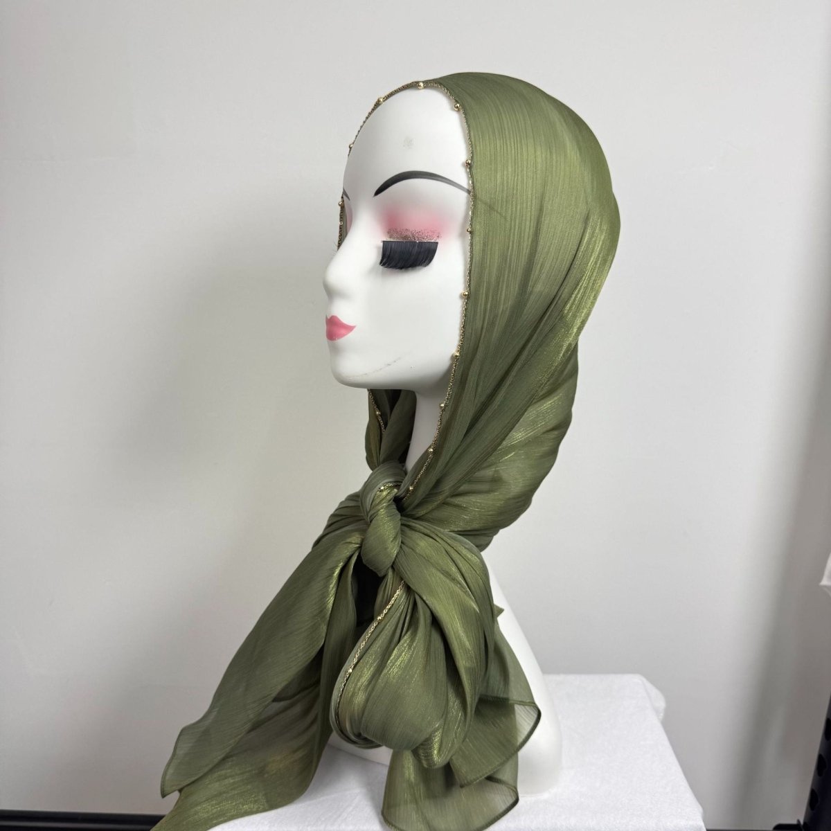 Full-length view of gold chain beaded hijab in fluid drape