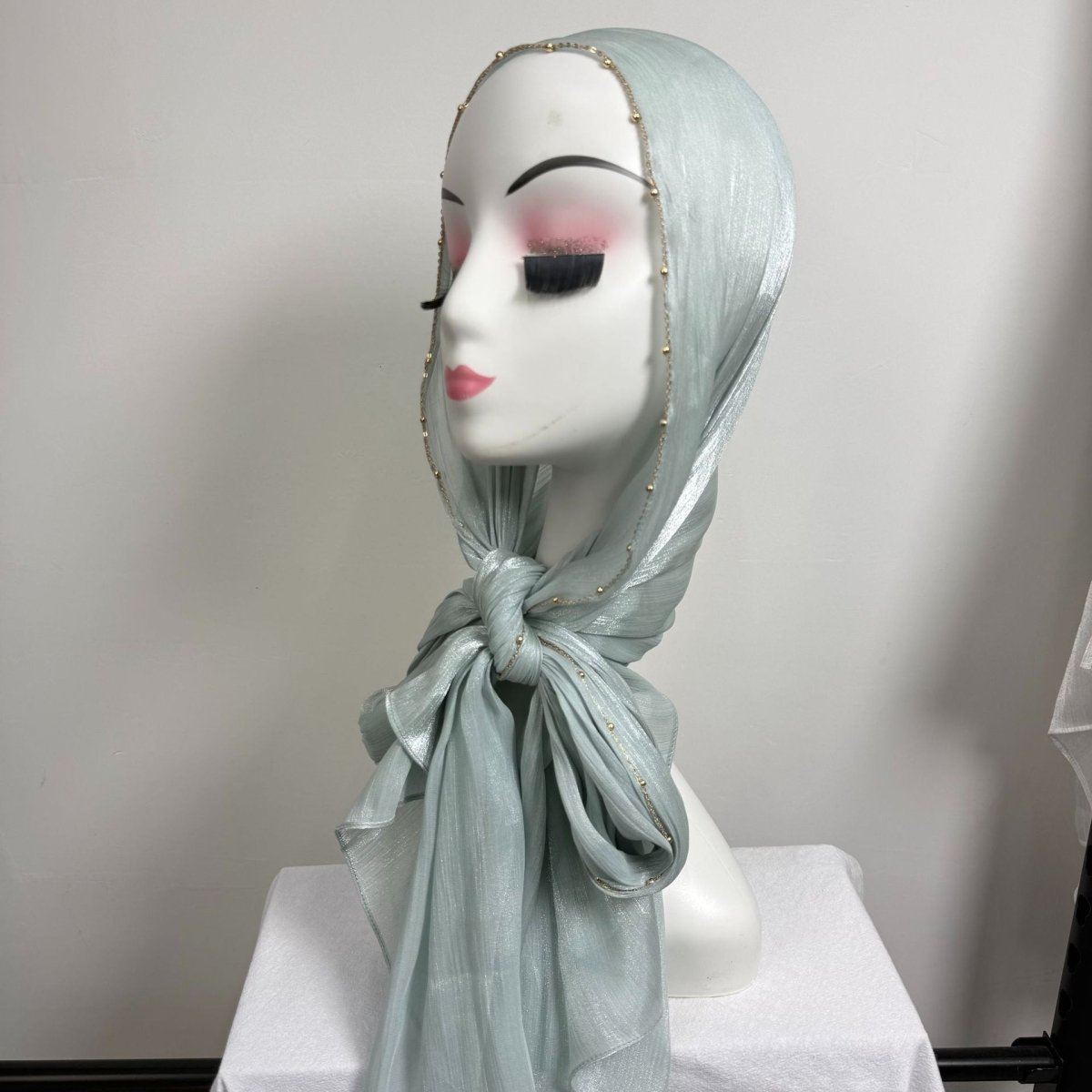 Side profile showing natural crinkle texture and shimmer finish of satin hijab