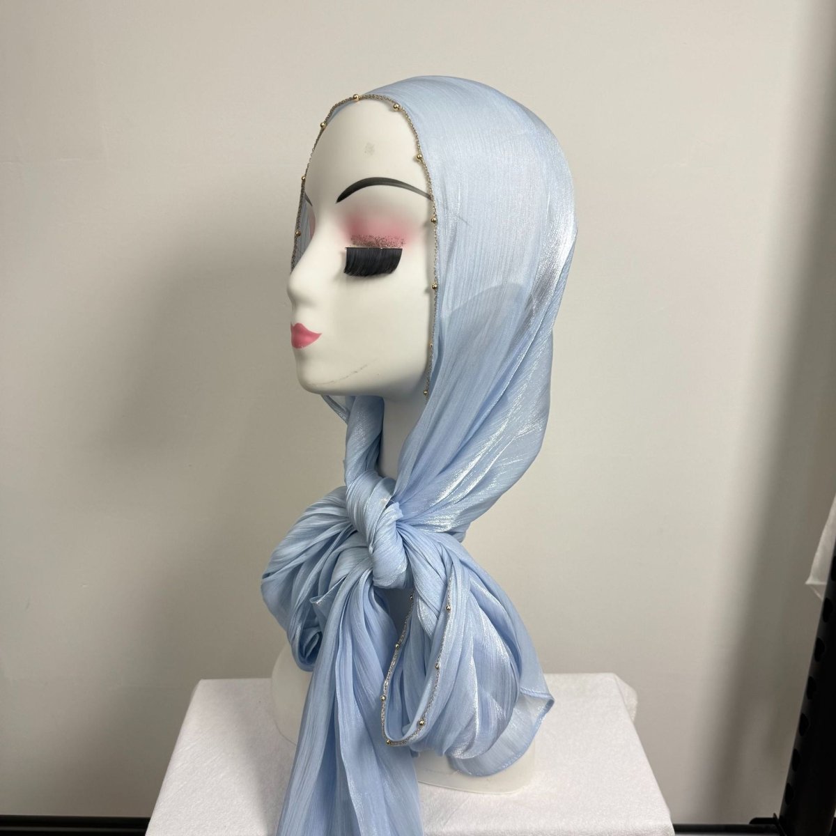 Back drape of gold chain beaded satin hijab showing even bead spacing