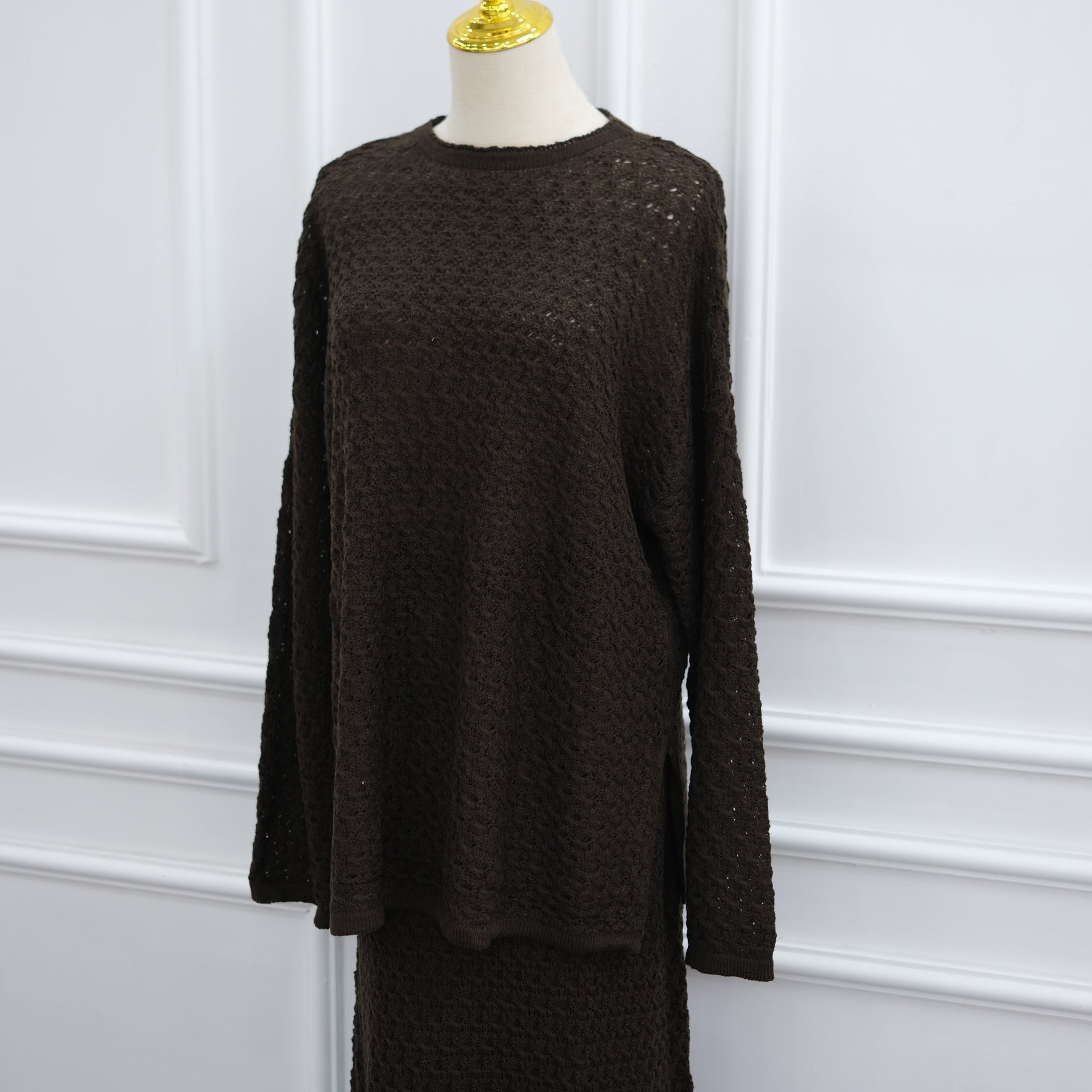 Styled flat lay of crochet knit sweater and maxi skirt co-ord set