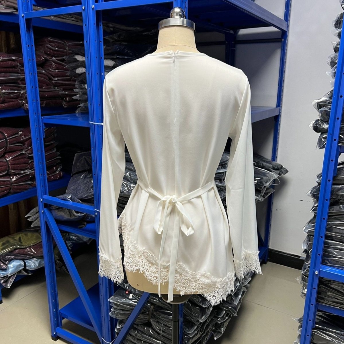Close-up of wide scalloped lace trim with intricate floral pattern along curved hem