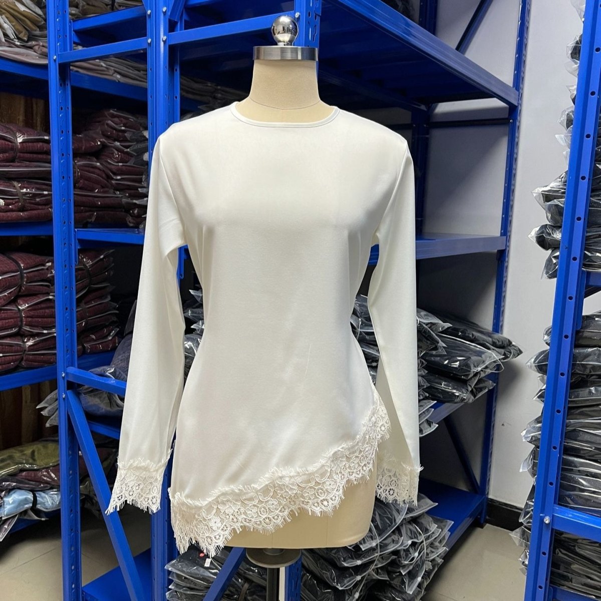 Back view of lace trim asymmetric hem top showing scalloped hem detail