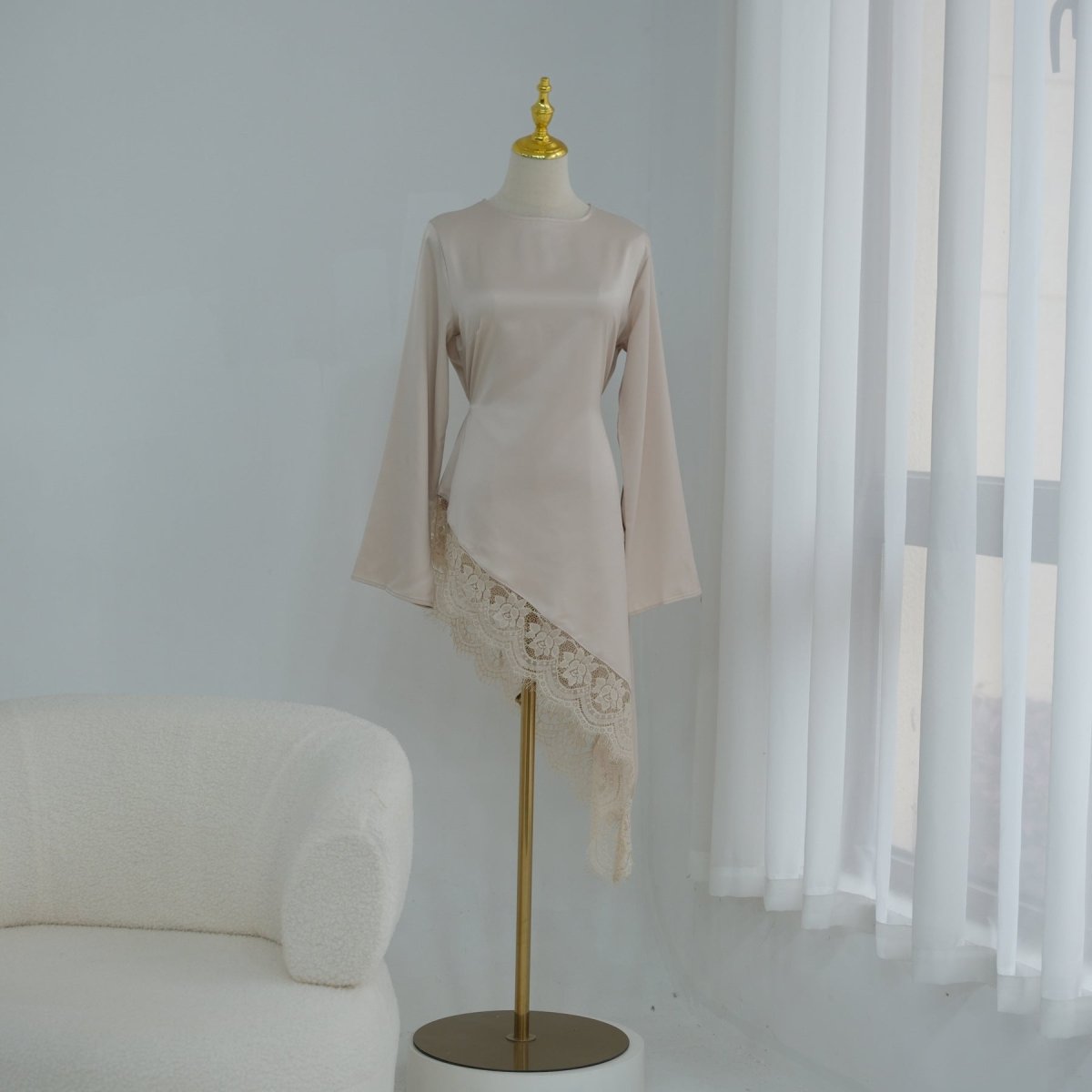 Close-up of tonal lace hem band on lustrous satin fabric