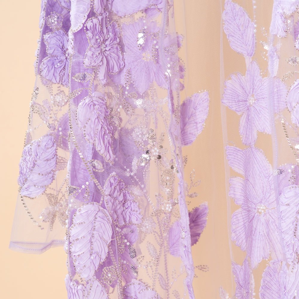 Close-up of hand-beaded floral appliqués on lavender mesh abaya