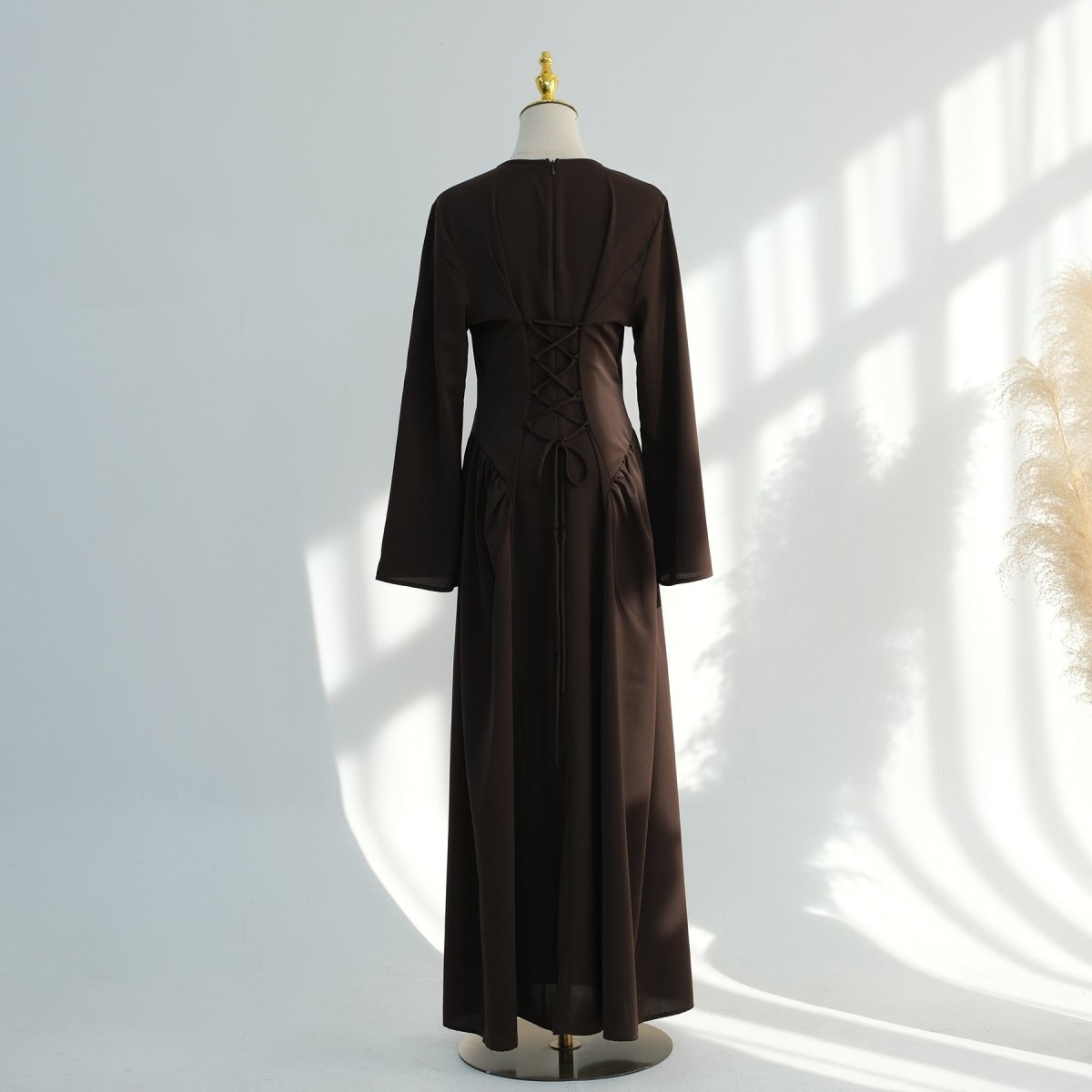 Sweeping hem of pleated nida flared maxi dress from below
