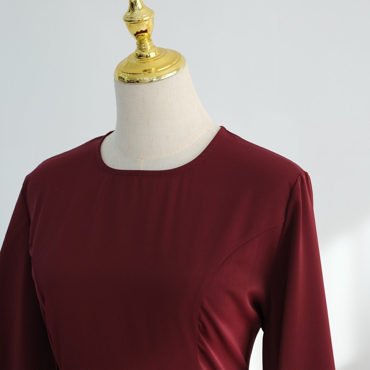 Sweeping pleated A-line skirt hem detail on nida flared maxi dress