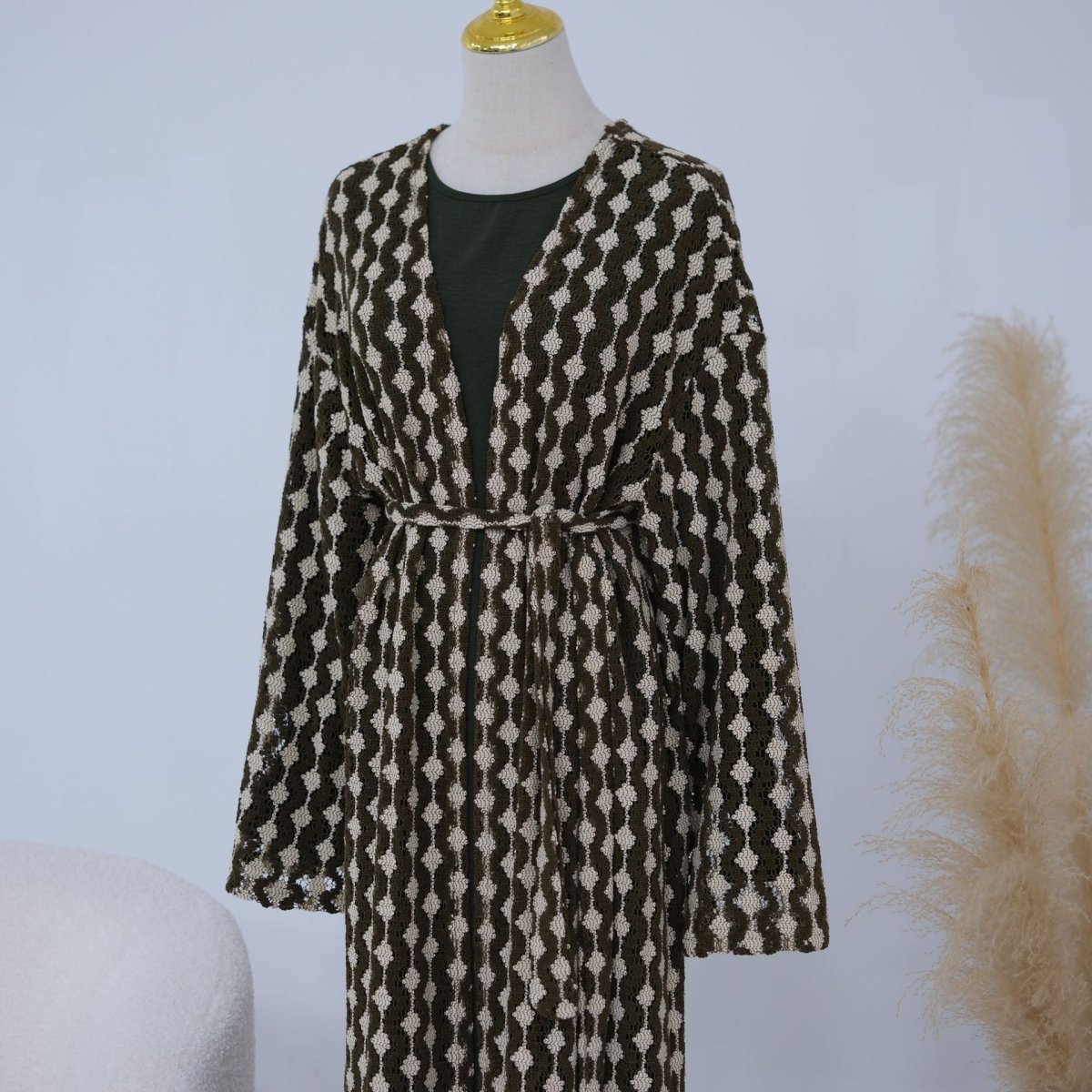 Full-length view of lace open abaya with defined waist from self-tie belt