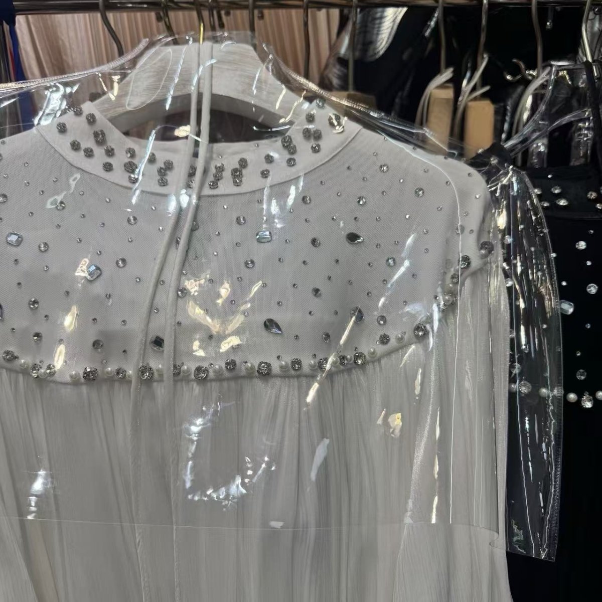 Close-up of scattered pearl and rhinestone bib collar effect