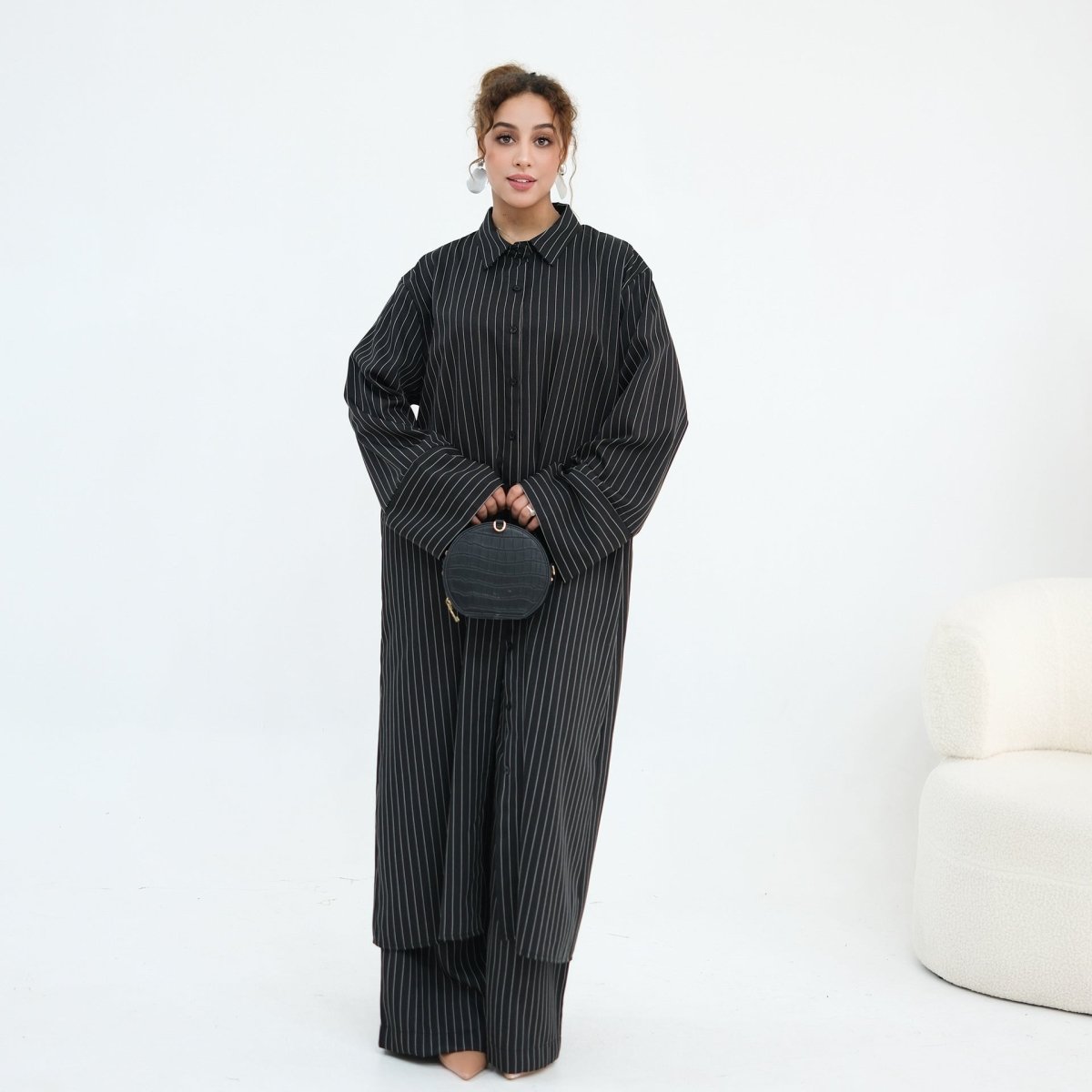 Walking motion shot showing wide-leg trouser drape at floor length