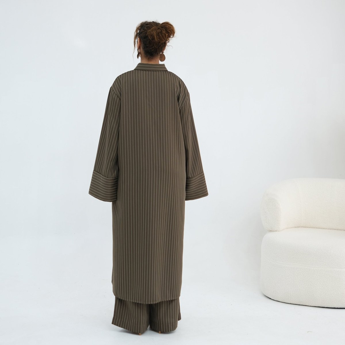 Shirt worn open as a layering piece over the matching pinstripe trousers