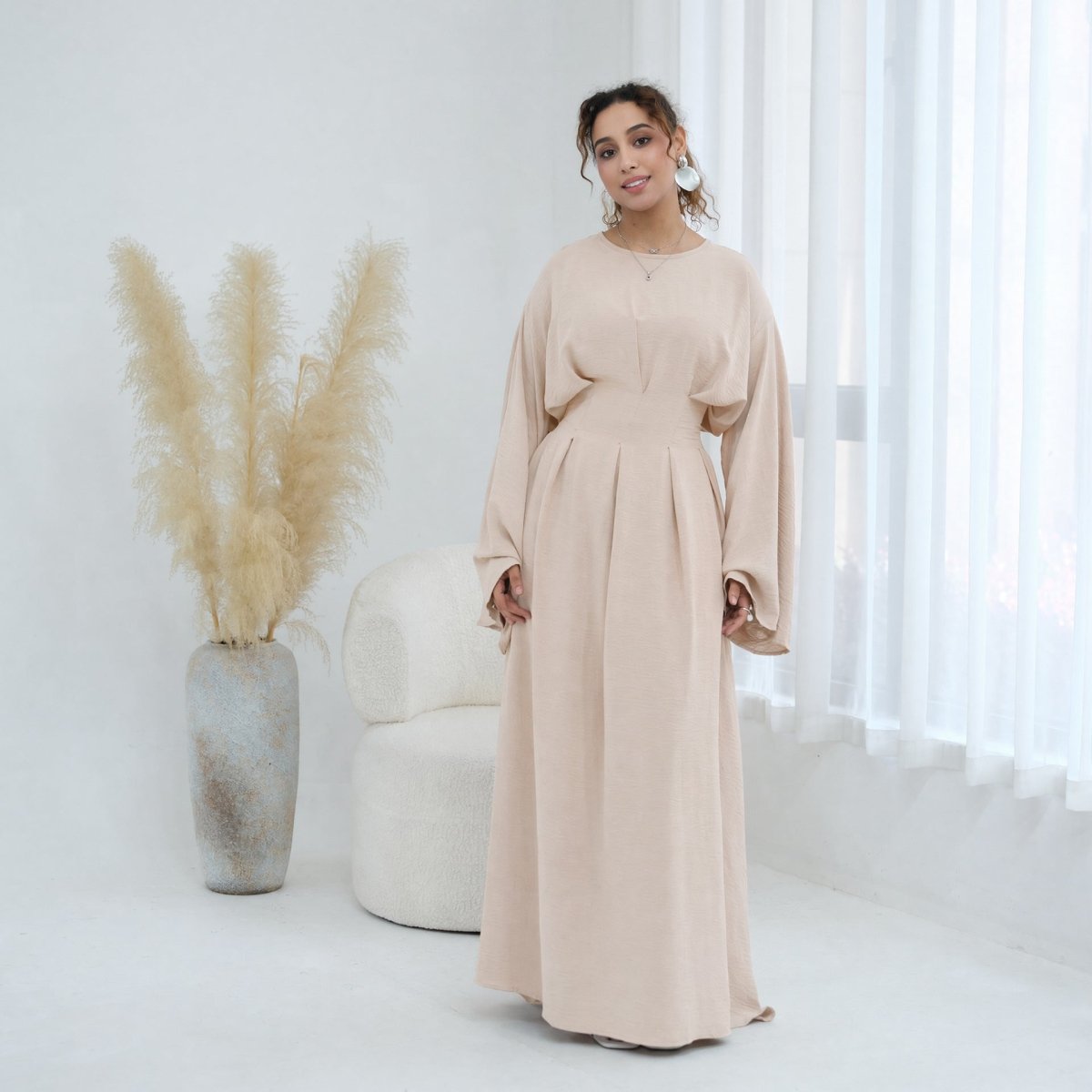 Full-length front view of matte crinkle fabric pleated maxi dress