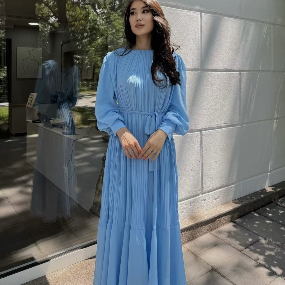 Draped movement of two-tier ruffle hem on pleated tiered maxi dress
