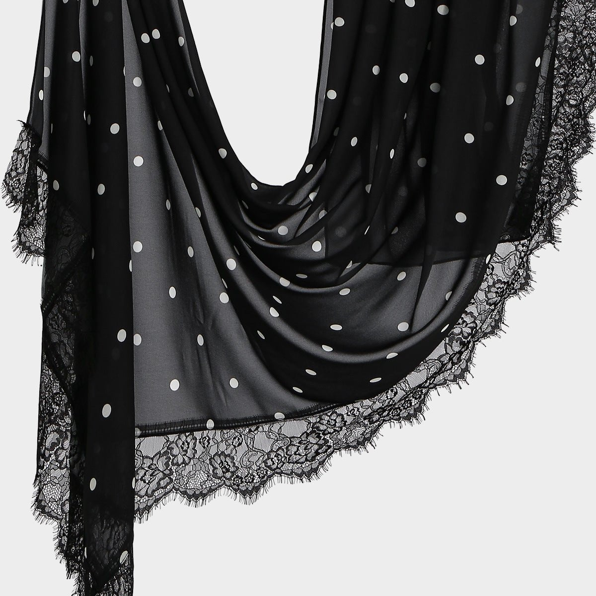 Side drape view of semi-sheer polka dot hijab scarf with floral lace edge