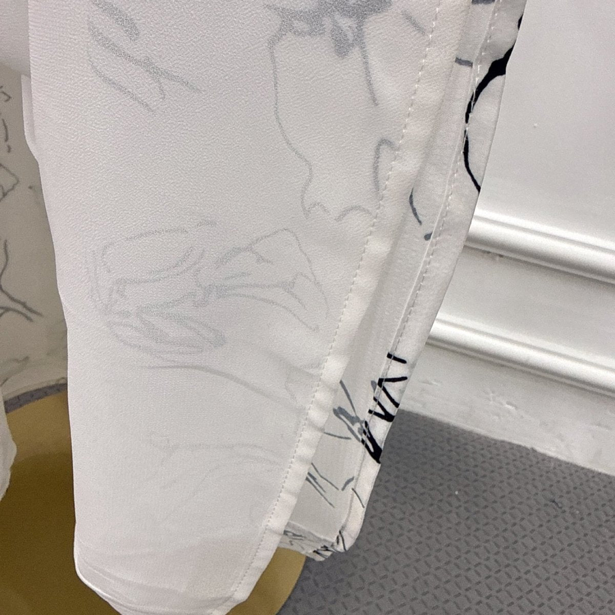 Close-up of smooth lustrous outer fabric on printed double-layer abaya