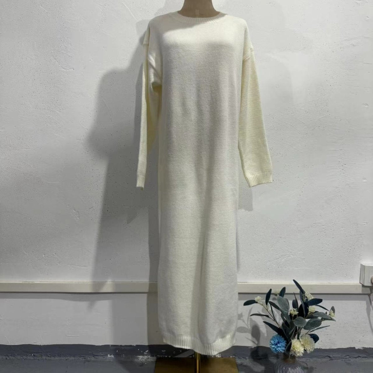 Close-up of ribbed cuff and hem detail on knit maxi dress