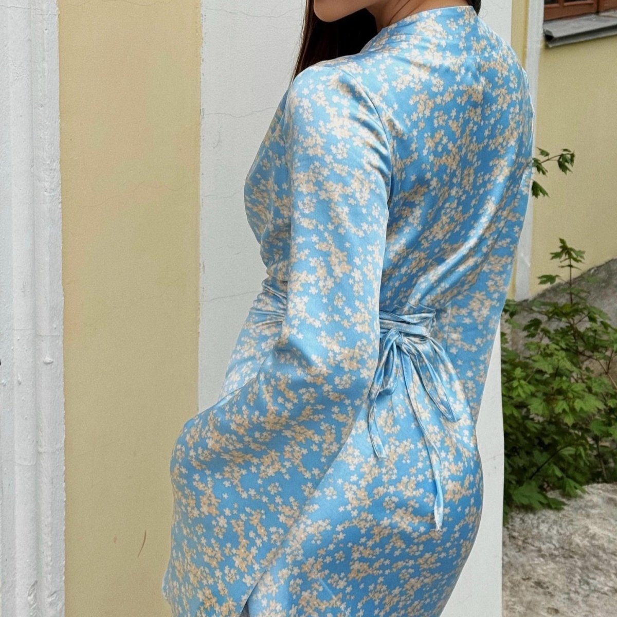 Scattered floral print close-up on ivory satin occasion maxi dress
