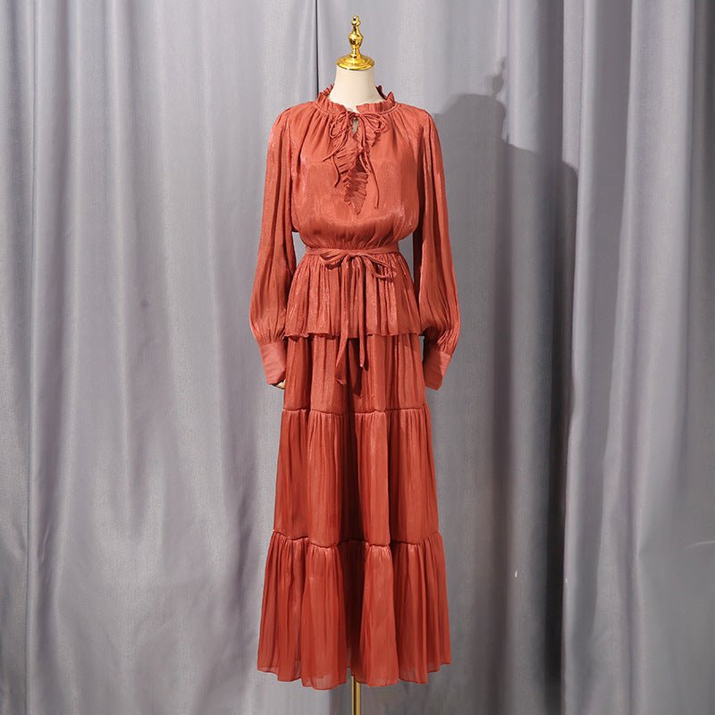 Close-up of ruffle bow neckline and tie detail on satin maxi dress