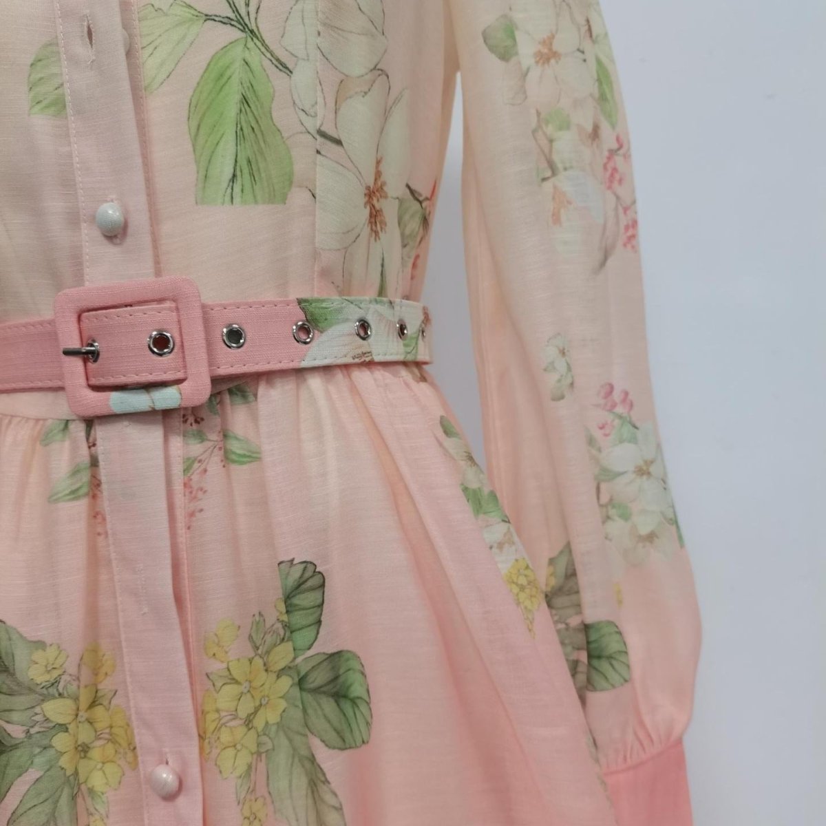 Back view of ruffle collar dress with gathered sleeve and flowing skirt detail