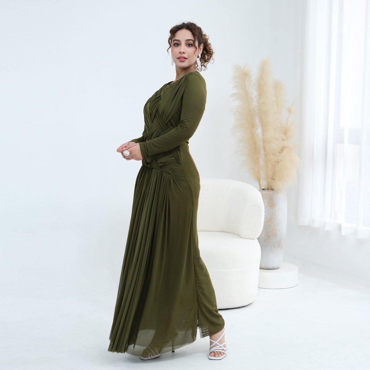 Modest mesh maxi dress shown in movement highlighting pleated skirt drape