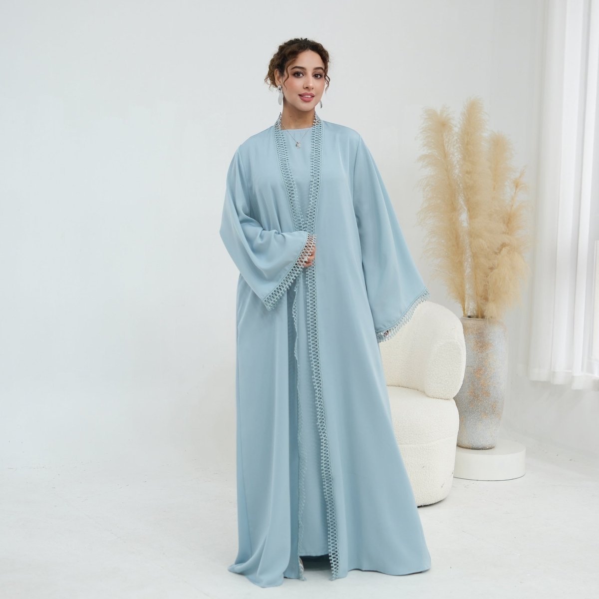 Front view showing tonal gold-silver spiral lace trim along open abaya panels