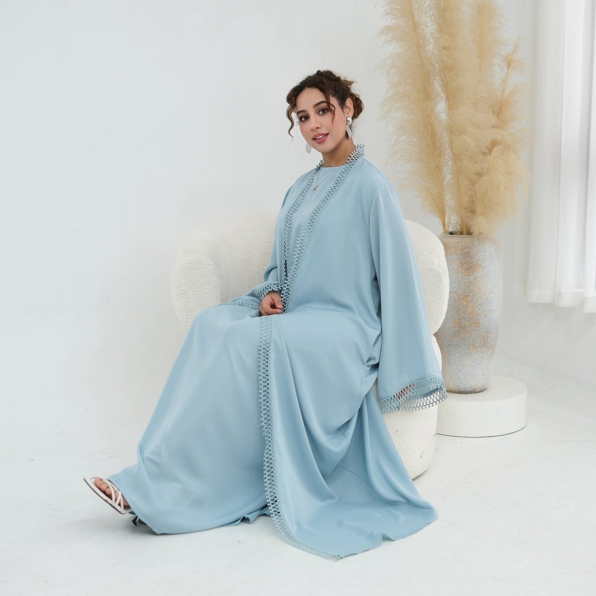 Lace trim detail at lower hem of open abaya front panel