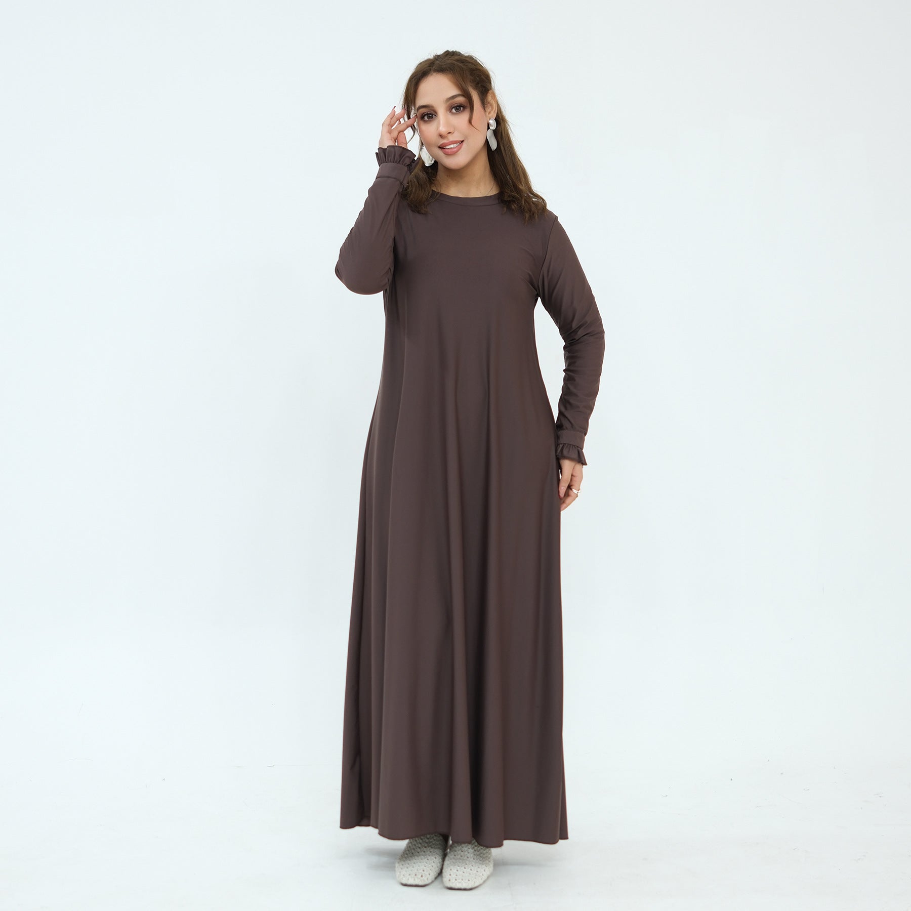 Coordinating waist belt laid flat alongside swim dress and pants