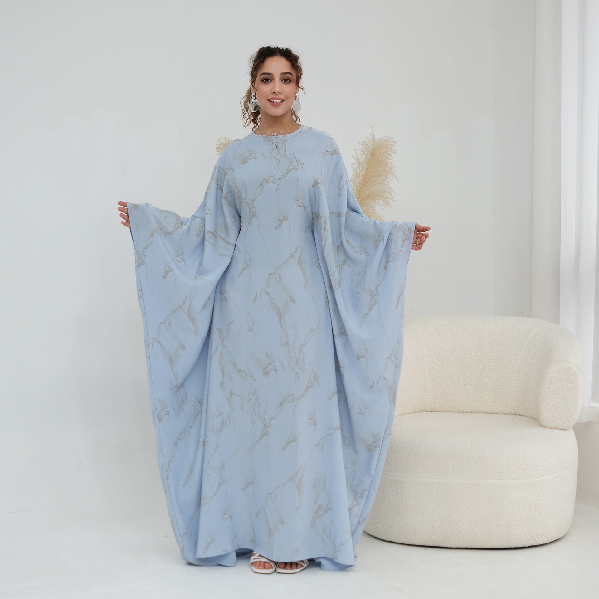 Three-quarter view of batwing sleeve abaya maxi dress in motion