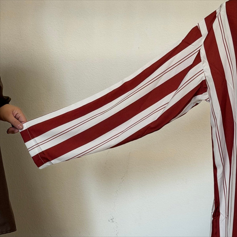 Oversized hood with white inner lining on full-length burgundy striped kaftan