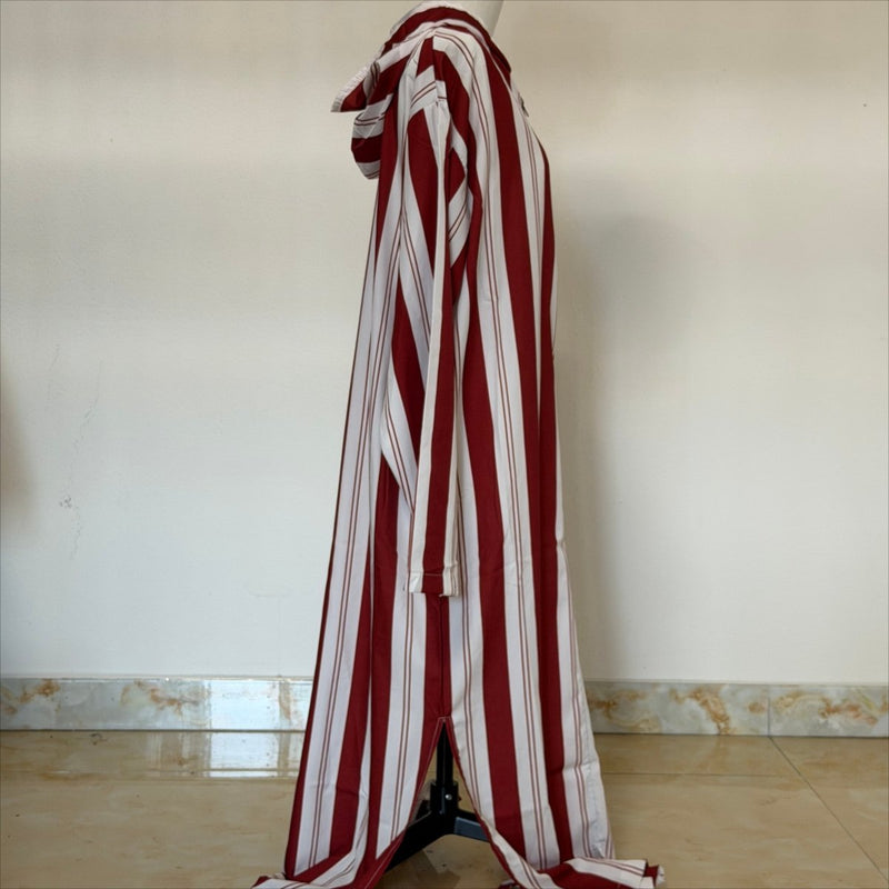 Close-up of burgundy half-zip placket and contrast woven tape detail on striped kaftan