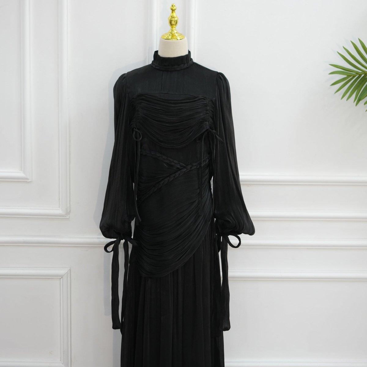 Hem detail of floor-length pleated skirt