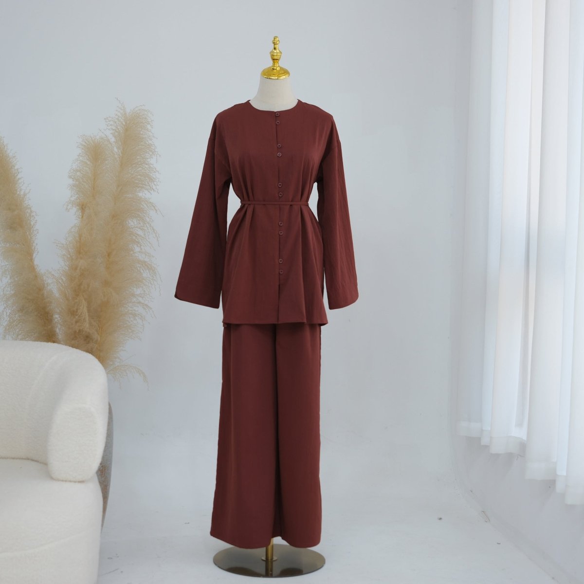 Complete modest two-piece set flat lay showing top, trousers and belt