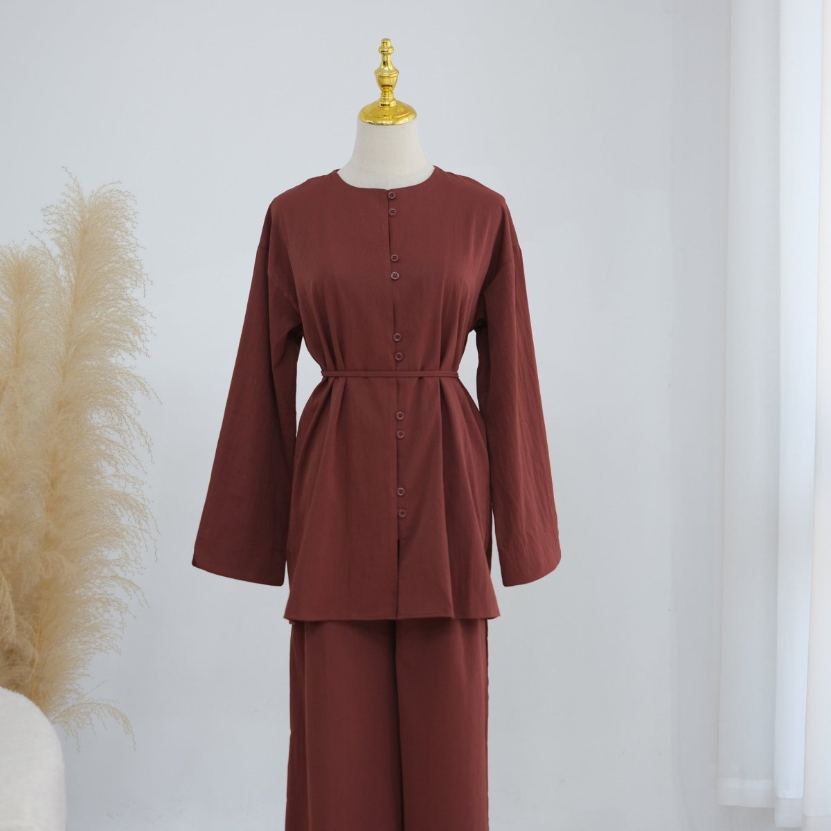 Close-up of self-covered tonal buttons on longline top
