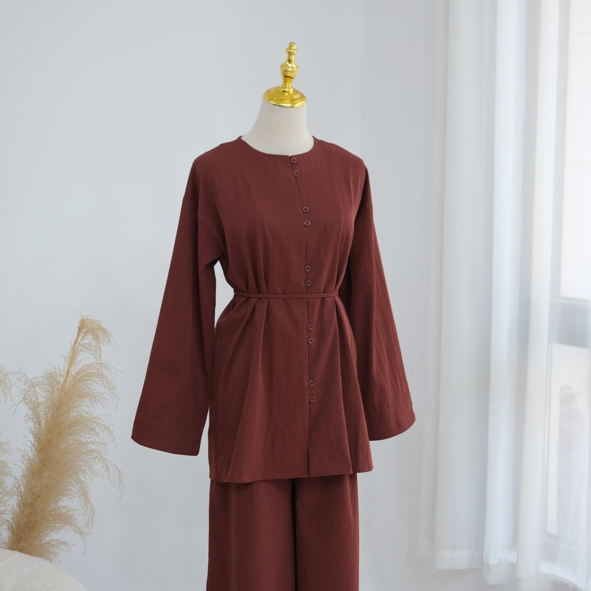 Round neckline and full button placket close-up on modest co-ord