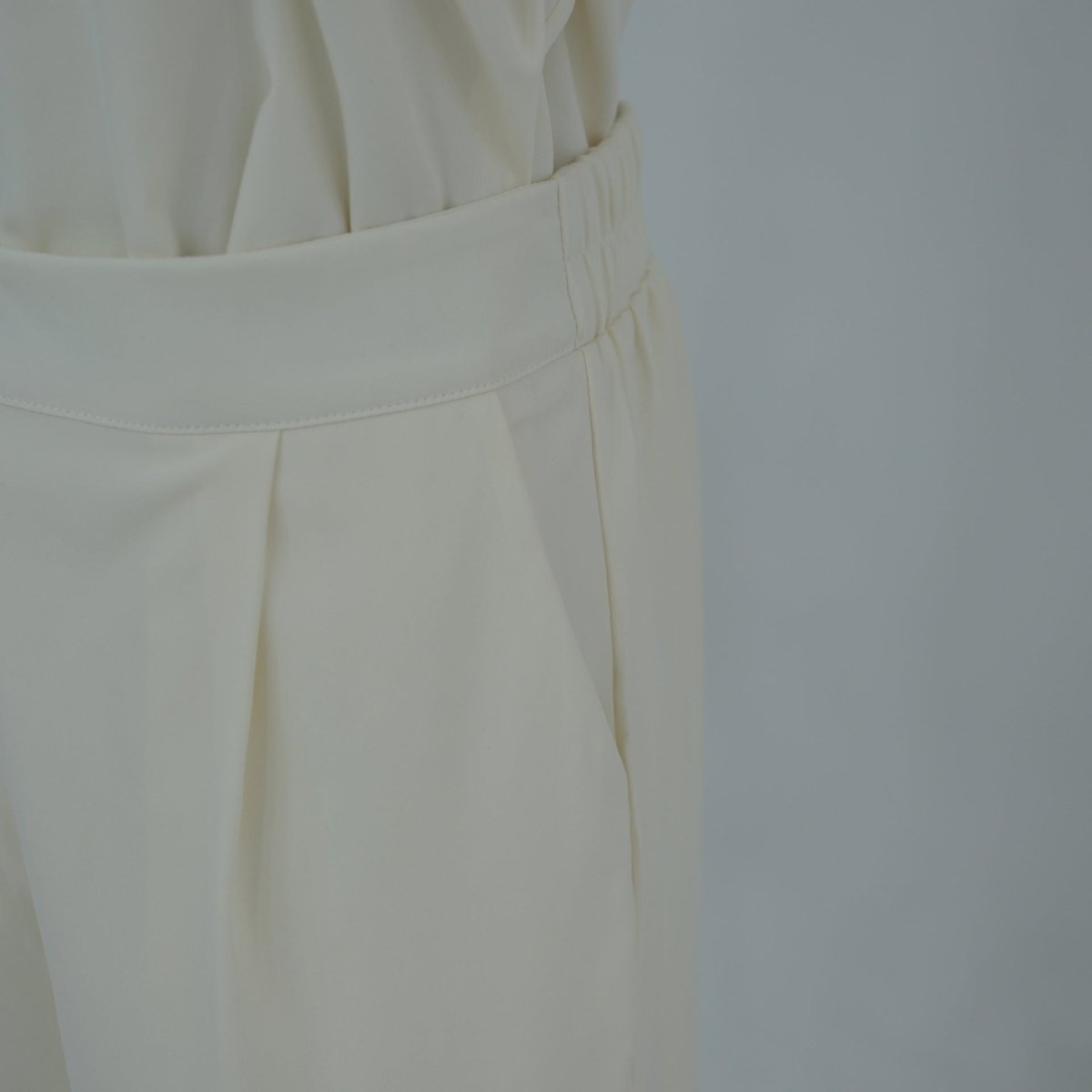 Front full-length shot of modest button-front longline top and trouser set